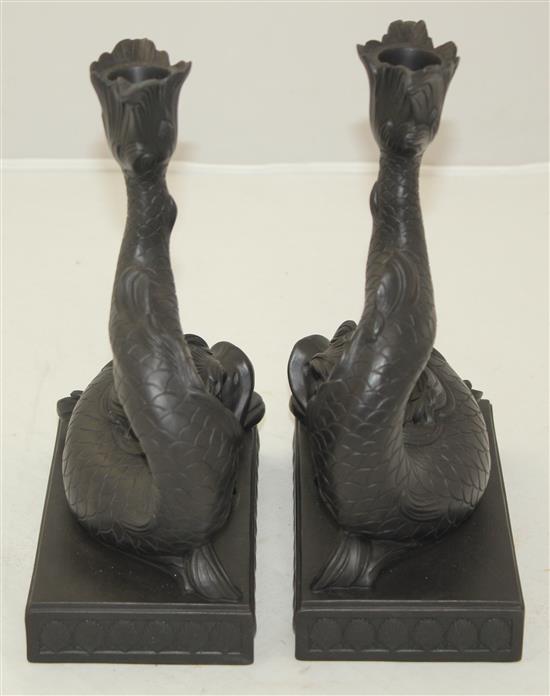A pair of Wedgwood black basalt dolphin candlesticks, 21.5cm